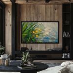 A 65-inch black oak framed TV displaying a serene nature painting, perfectly blending your modern television into dark wood built-ins and moody interior design.