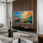 Stunning 85-inch custom ornate silver bezel seamlessly integrating a massive flat-screen TV into upscale home decor.