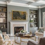 A 55-inch TV beautifully disguised as classic landscape art above a traditional living room fireplace using a premium antique gold frame.