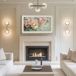 A 65-inch television elegantly disguised as a framed masterpiece over a sleek fireplace, showcasing how the custom silver bezel instantly elevates your room's decor.