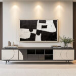 A 55-inch wall-mounted TV beautifully camouflaged as modern gallery art using a custom silver frame, perfectly integrating technology into a stylish entertainment center.