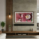 A 65-inch framed TV displaying vibrant orchid art above a wooden console, showing how the rich walnut finish perfectly complements organic textures and modern interior styling.