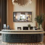 A gorgeous 75-inch framed TV displaying a tropical beach scene behind a modern hotel reception desk, elevating your commercial space with a welcoming, premium aesthetic.