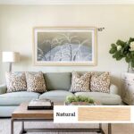 Natural light oak TV frame disguising a flat screen as a framed painting. Brightens the living space and provides a seamless, gallery-quality look for a minimalist or airy aesthetic.