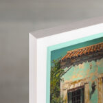 A chic EventFrame in white with a turqoise inner line displayed in a maximalist living room. The 1-inch pine frame provides a crisp border for colorful pop art prints.