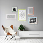 Personalized white frame with a navy blue inner border by EventFrame in a child’s nursery. The playful pop of color adds character to whimsical wall art.