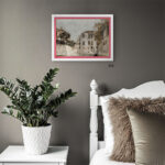 Two-toned white and orange wood frame by EventFrame displayed in a stylish urban loft. The slim colorful edge provides a sophisticated look for modern photography in sizes like 16x20 or 18x24.