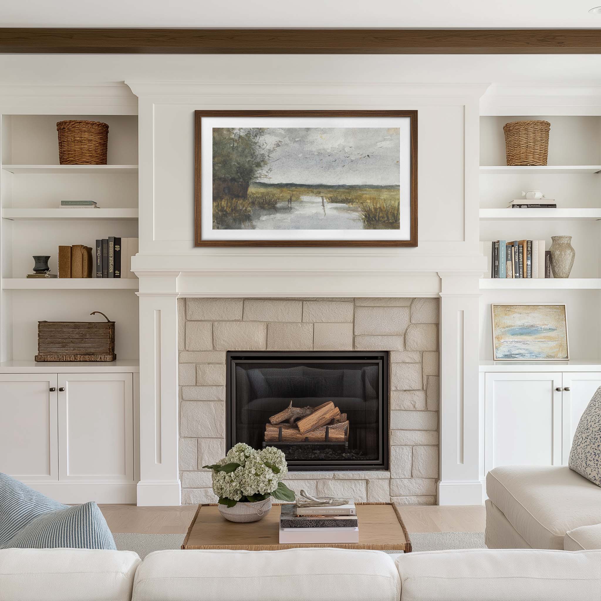 Wall mounted walnut tv frame above fireplace with wood beam, a standard stone fireplace