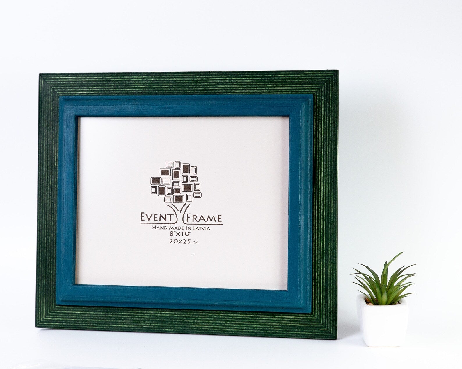 Green picture frame with a white mat displaying a logo on a white background. blue and green double color picture frame from solid durable long lasting materials birch hardwood in stripy texture design