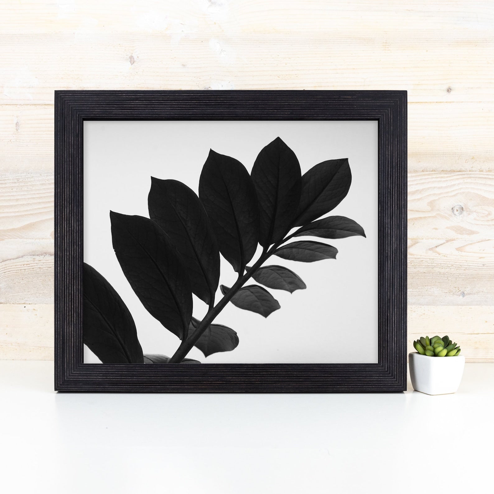 Framed black leaf print on a white surface with a light wood background. Black Picture Frame, Wooden Photo Frame, Rustic Stripy Design Frame, Dark Academia Decor,Diploma Frame A1 A3 A4 8x10 11x14 12x18 18x24 20x30