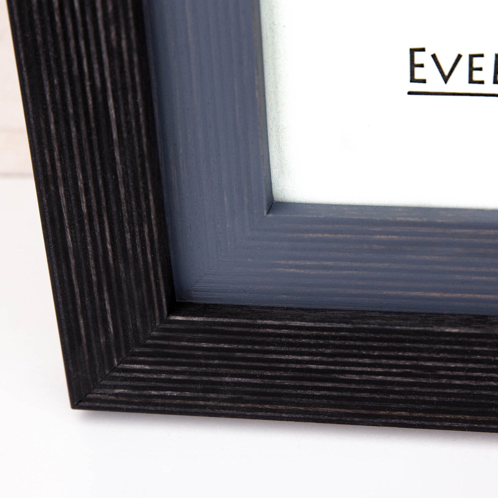 Close-up of a textured black picture frame with 'EVENT FRAME" logo. Black + Grey Handmade Picture Frame, Photo Frame with Wooden Mat, Two Tone Poster Wall Frame, Custom Sizes A1 A2 5x7 8x10 18x24 24x36 20x30