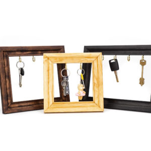 Wooden key holder frame in three different color variations in brown, natural and black.