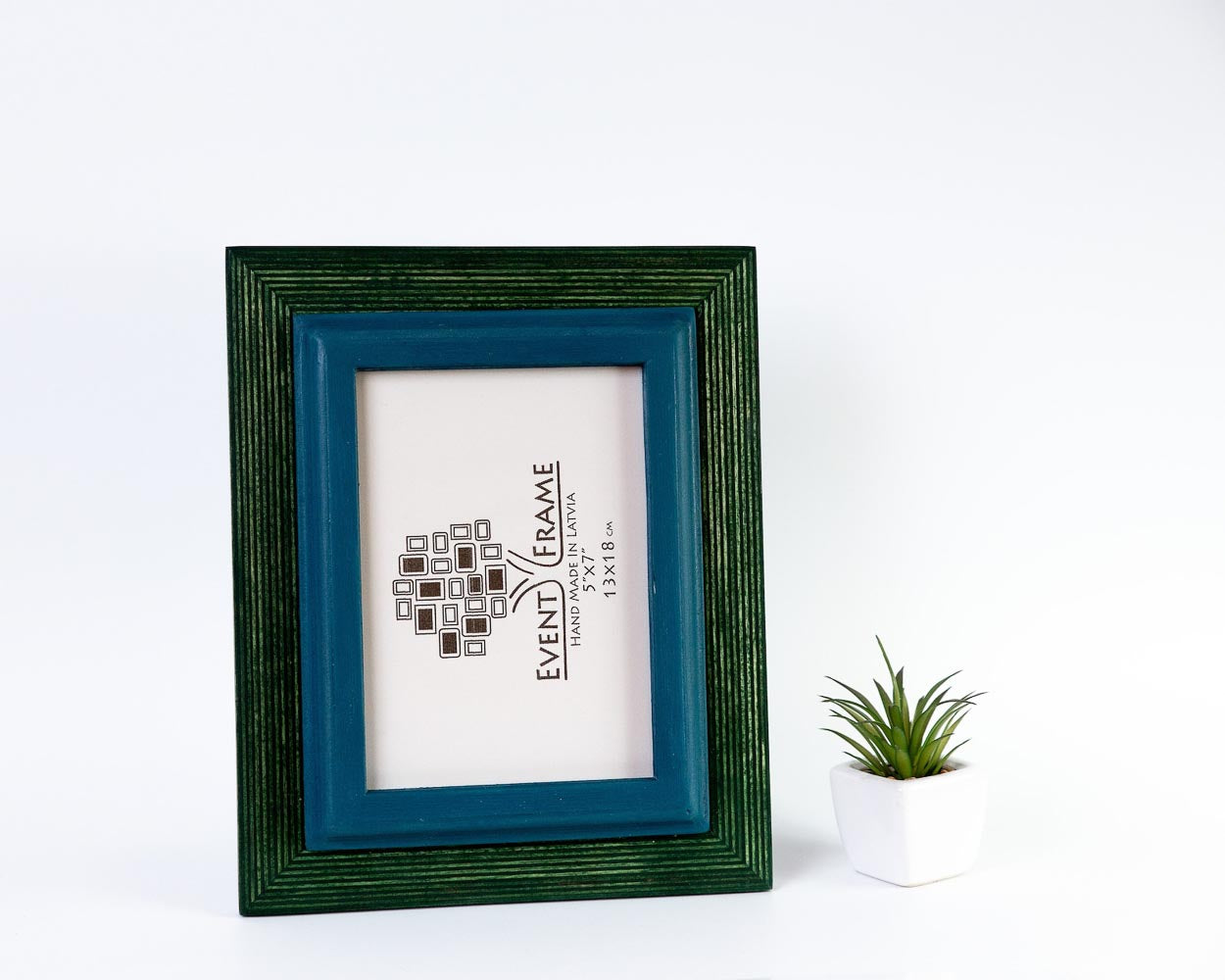 blue and green picture frame, blue picture frame,  white distressed desk, white pot and green plant