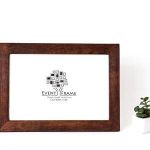 A brown modern design photo frame made from solid birch hardwood, displayed with a custom photo insert of EventFrame, standing upright with a white background and a small potted plant to the side. Custom wooden picture frame, birch hardwood, brown walnut color, handmade quality, custom sizes A4, A5, A3, 8x10, 5x7, 20x30, 14x18, 22x28
